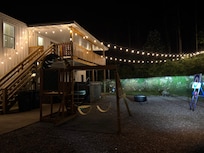 The string lights which reach to the hillside are a wonderful touch!
