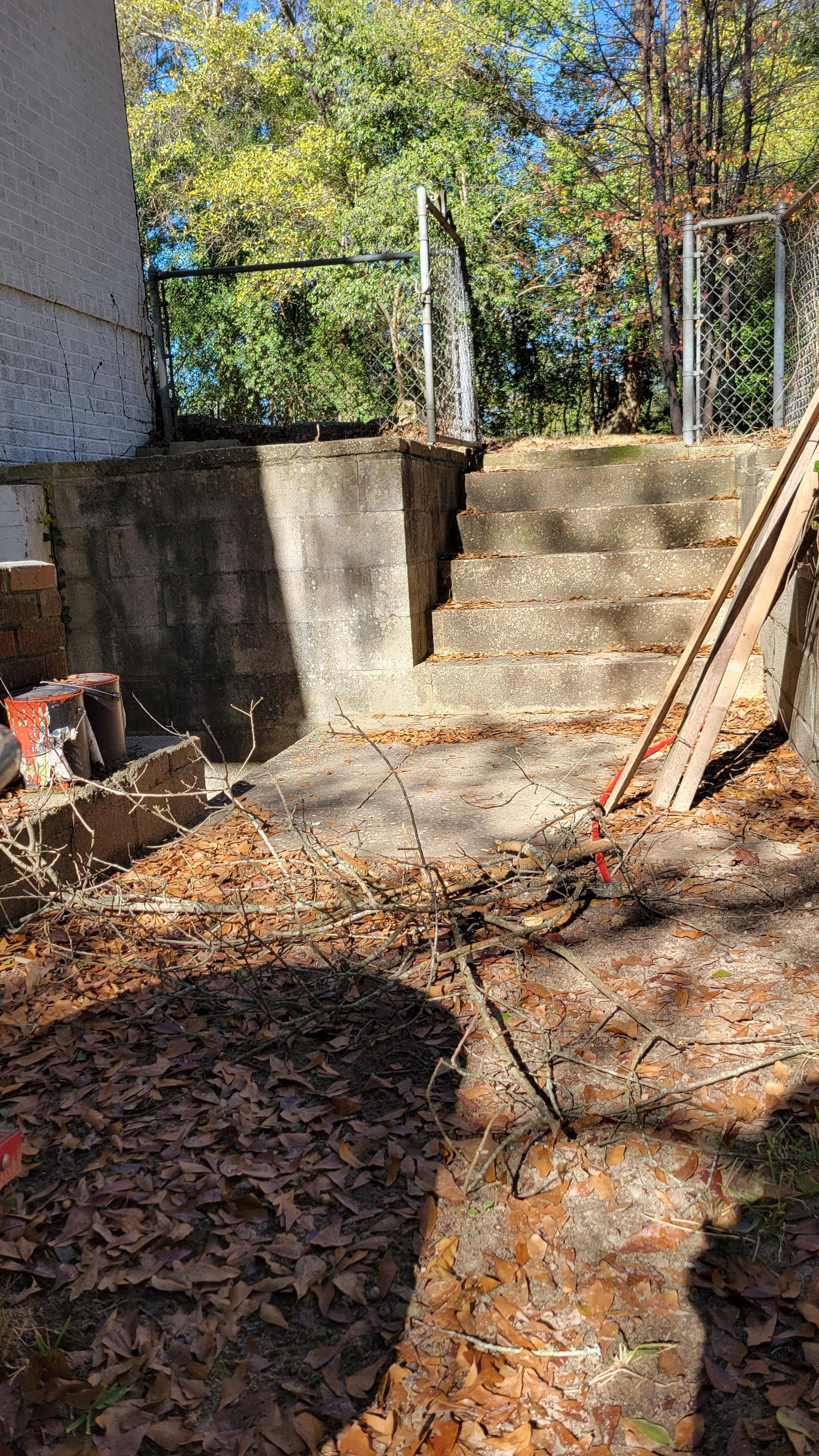 Sticks and boards in the way of steps leading from front to back yard