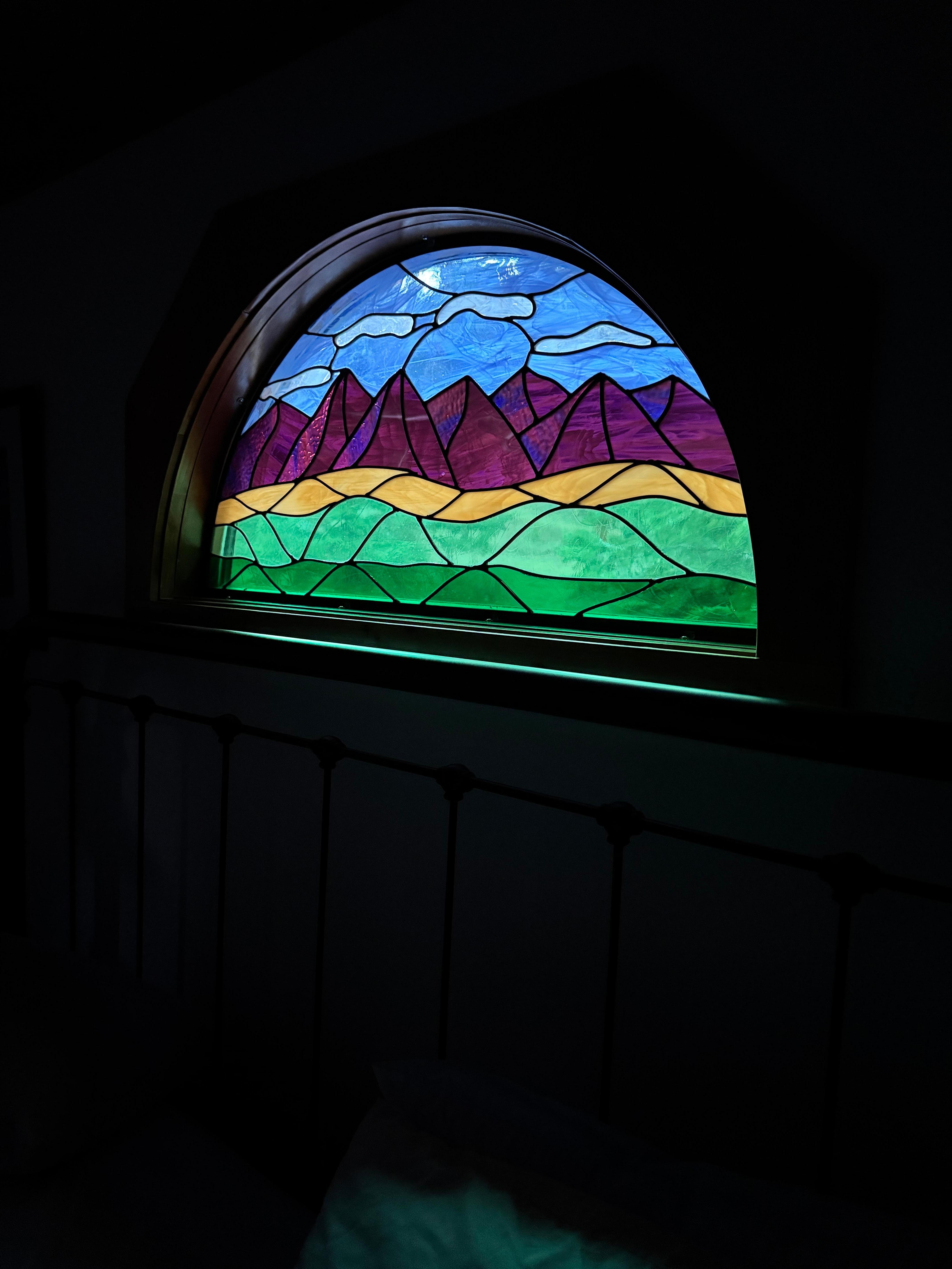 The beautiful stain glass window over the bed
