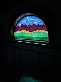 The beautiful stain glass window over the bed