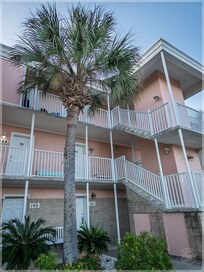 Building front. The unit is on the second floor facing the steps.