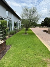 This is standing at the front door looking towards the entrance. Building on left is main area: kitchen, dining, living room which looks onto pool
