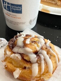 Orange juice and hot cinnamon roll