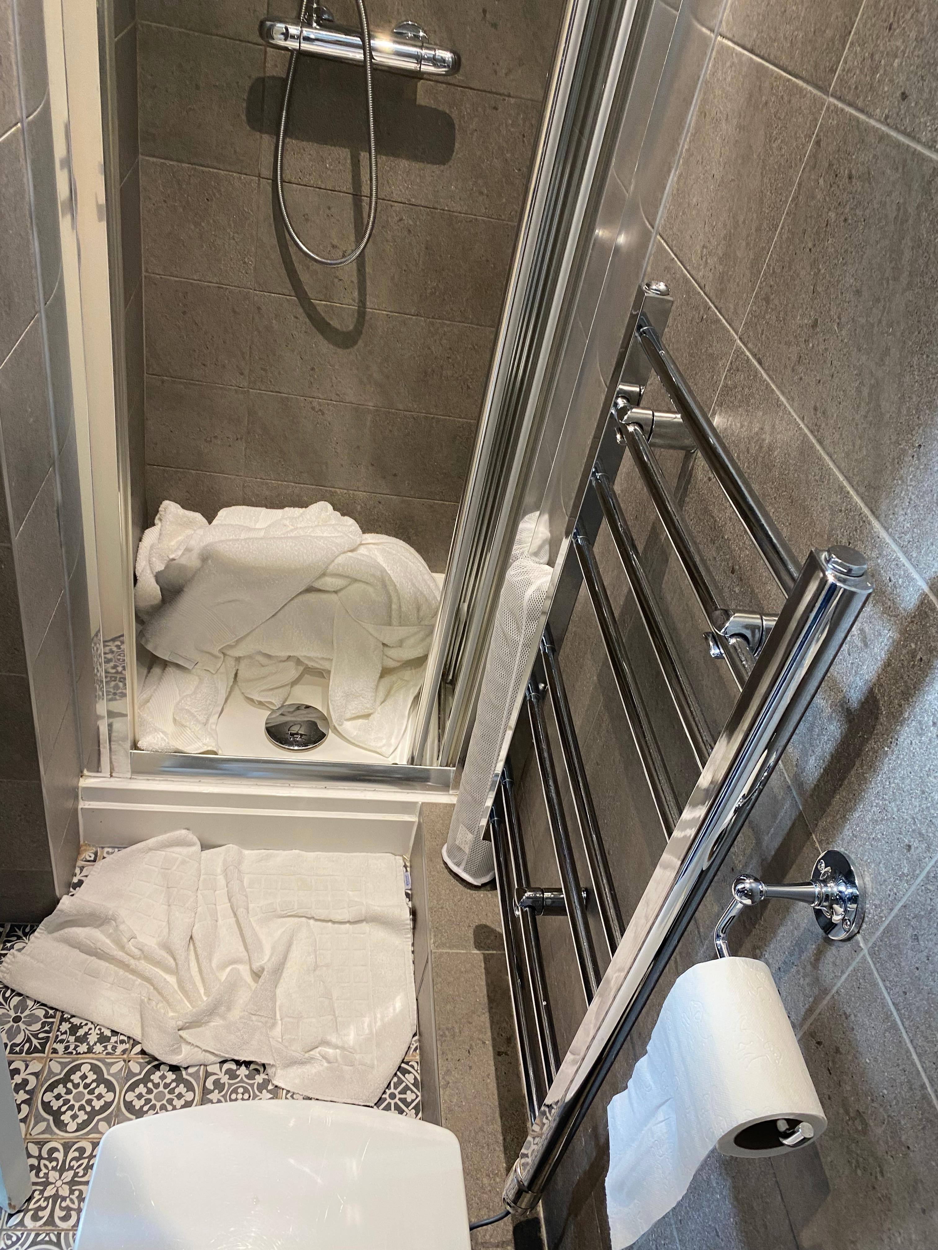 The narrow shower cubicle. Sorry, should have cleared the old towels, but we were just leaving