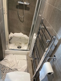 The narrow shower cubicle. Sorry, should have cleared the old towels, but we were just leaving