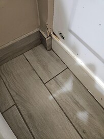 Where the tub was leaking from. You can also see the 6" elevation of the tub. Photo and lighting do not adequately show the water on the floor.
