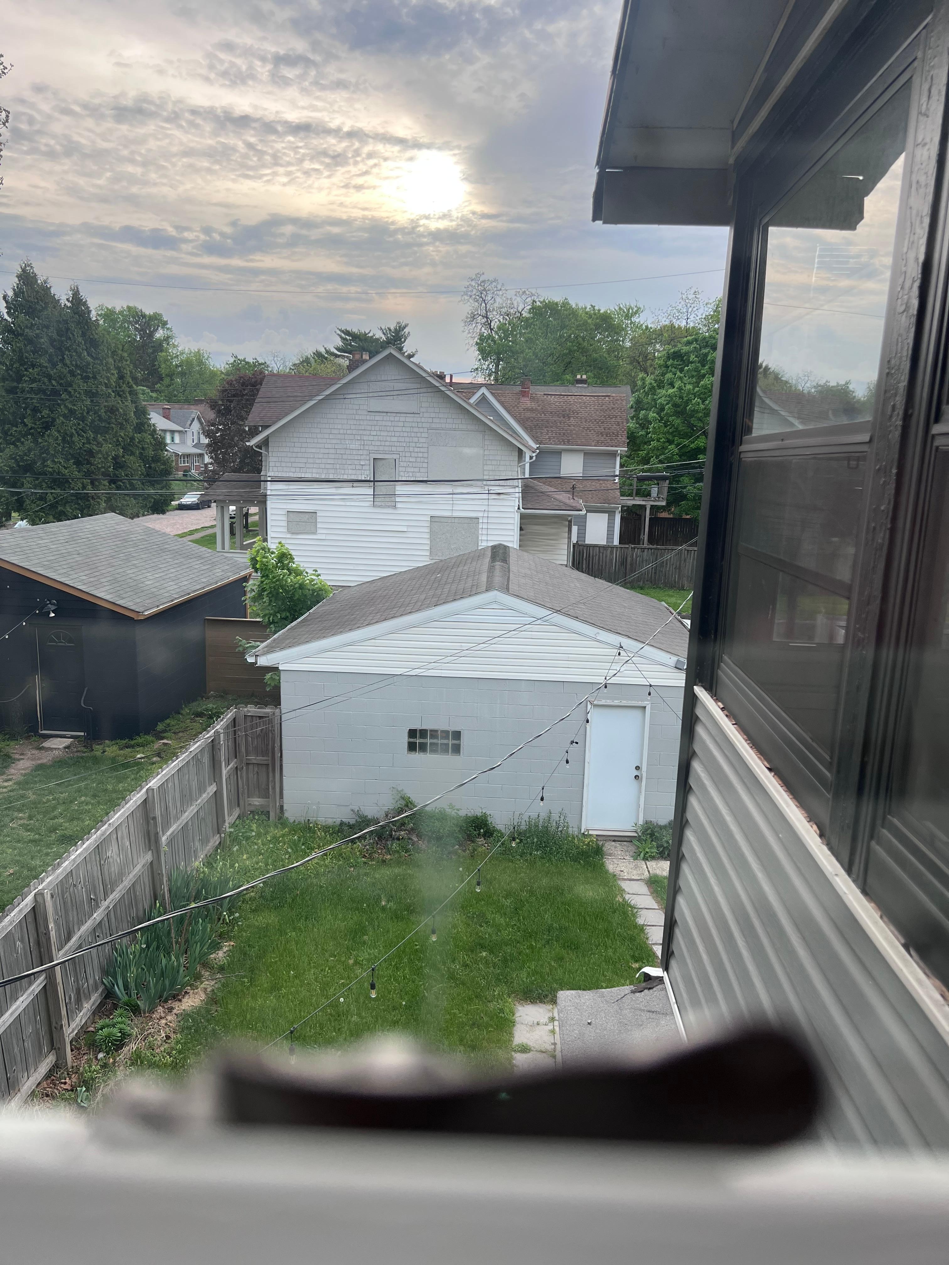 Grass needing cut and the boarded up houses