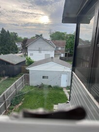 Grass needing cut and the boarded up houses