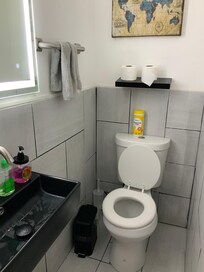 TP needs a wall hanging area or a stand. Shelf only helpful for extra rolls. Can’t reach once seated.