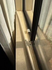 Wall paper peeling away at window sill
