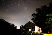 Shot of the cabin and the Milky way in the background