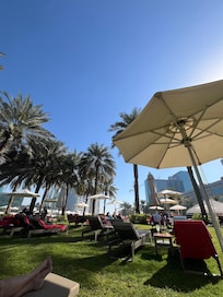 Grass area near pool
Three is also beach loungers and pool loungers