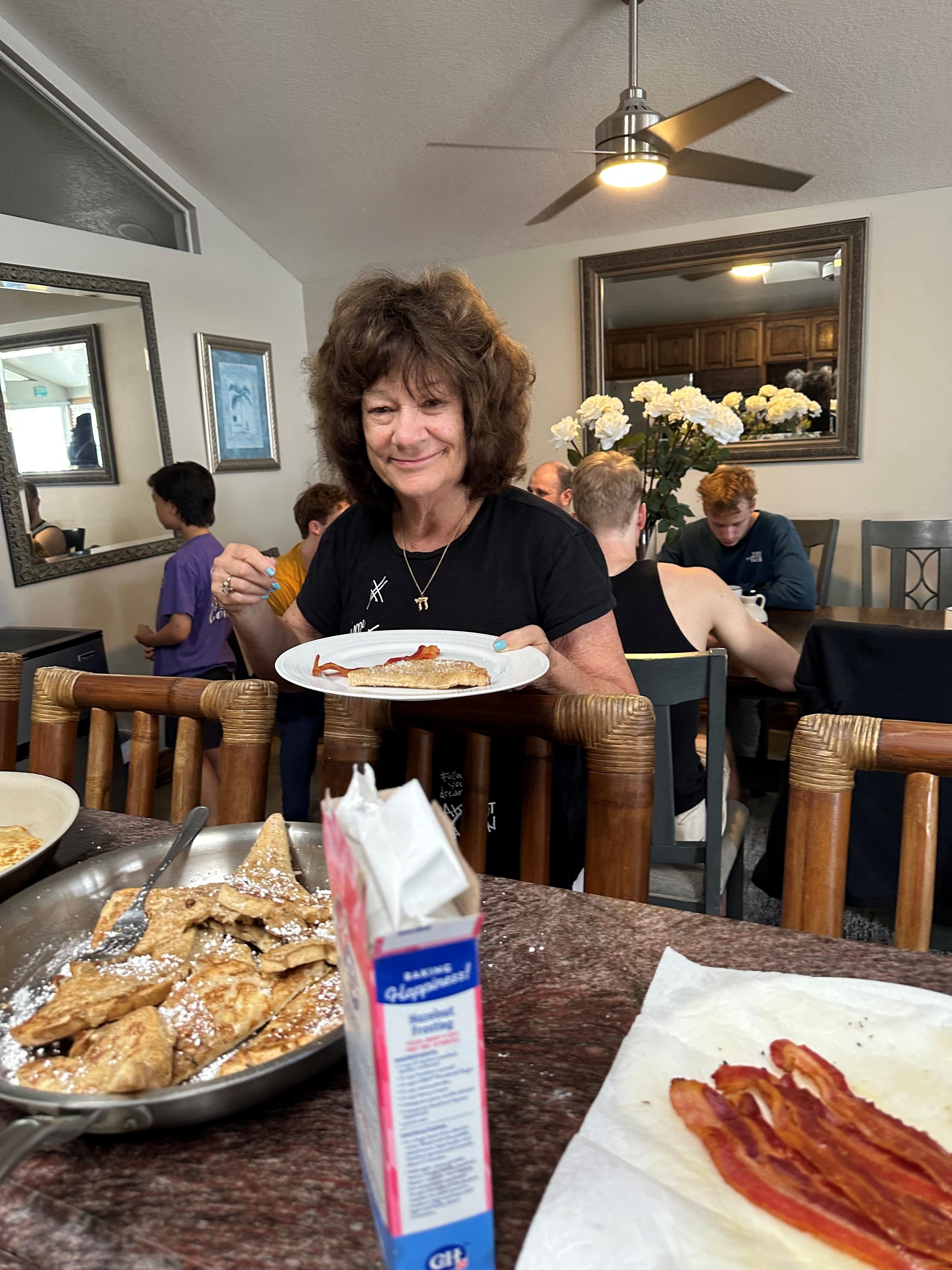 The birthday girl enjoying a family pancake breakfast on the 2nd floor of the house. The house has two kitchens. 