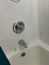 Water leaking behind faucet