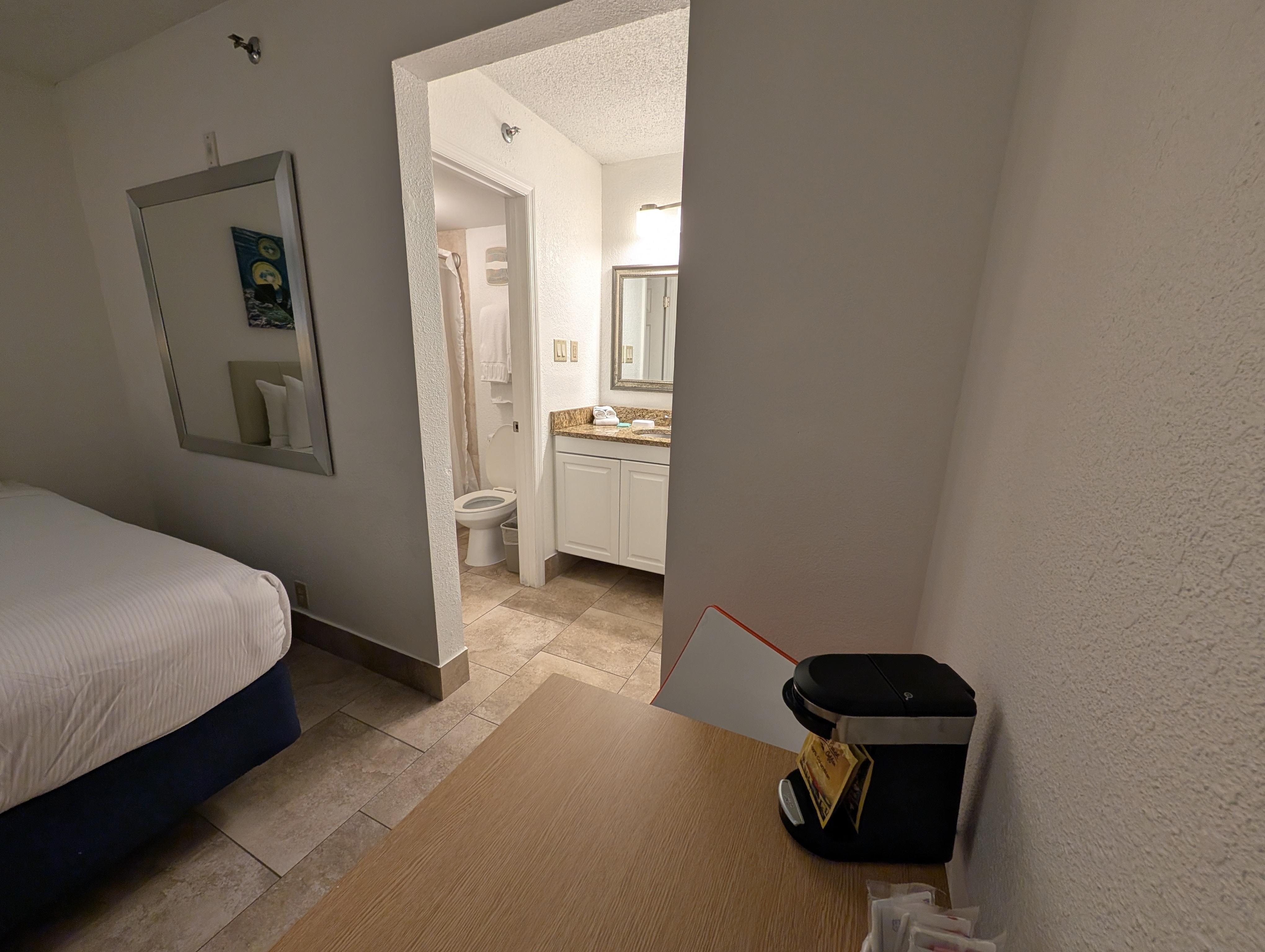 small table with 2 chairs and coffee maker