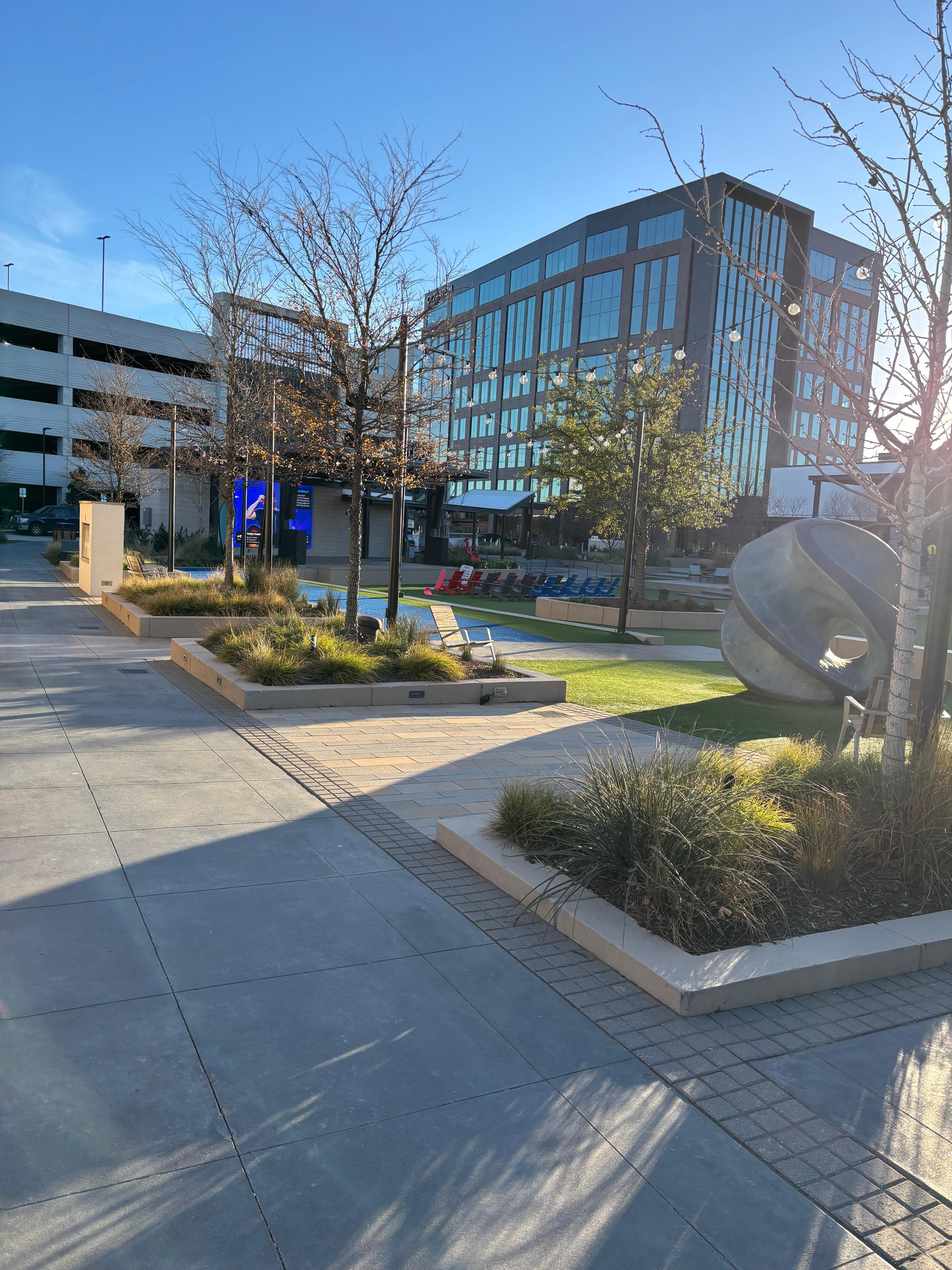 Outdoor area next to the hotel with and big screen and lawn chairs and other activities.