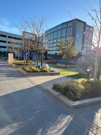 Outdoor area next to the hotel with and big screen and lawn chairs and other activities.