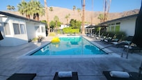 The large pool (with adjacent jacuzzi) is surrounded by high end chaise lounges and plush towels.