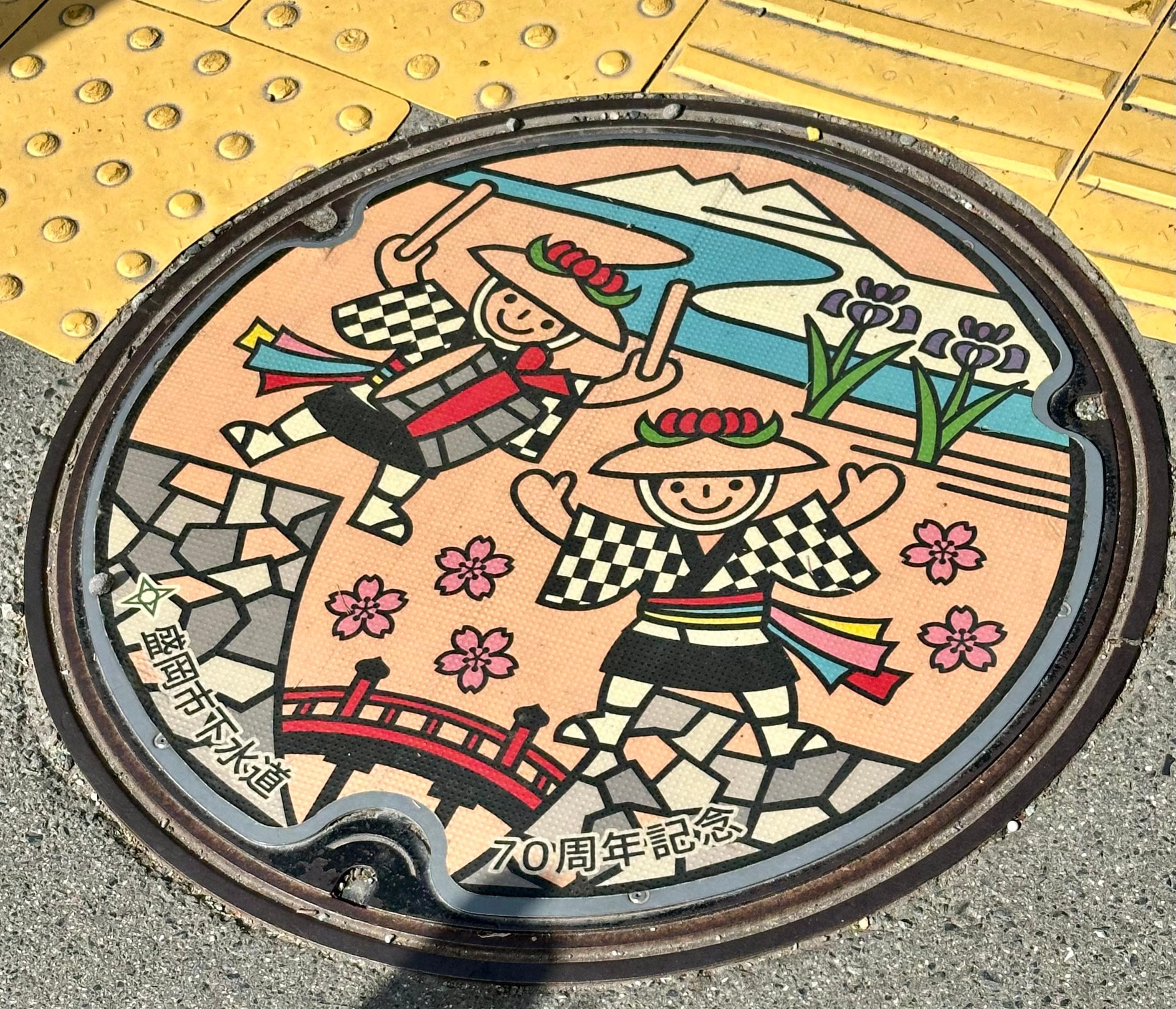 Love this colorful manhole cover near temple. 