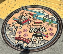 Love this colorful manhole cover near temple.