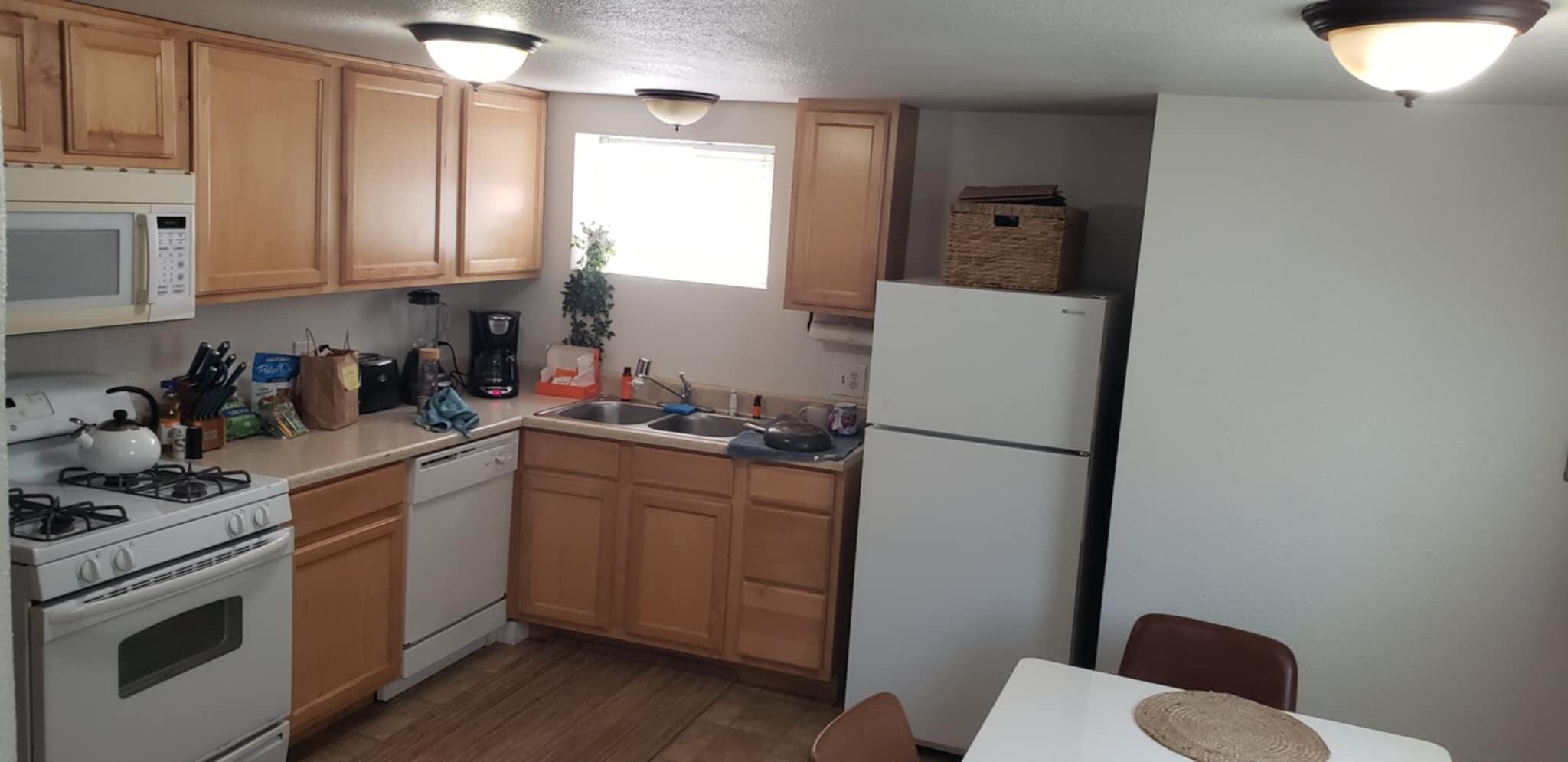functional stocked kitchen with spices and oil and coffee
