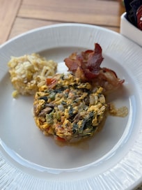 Egg Scrambled with choice vegetables, bacon, and potatoes