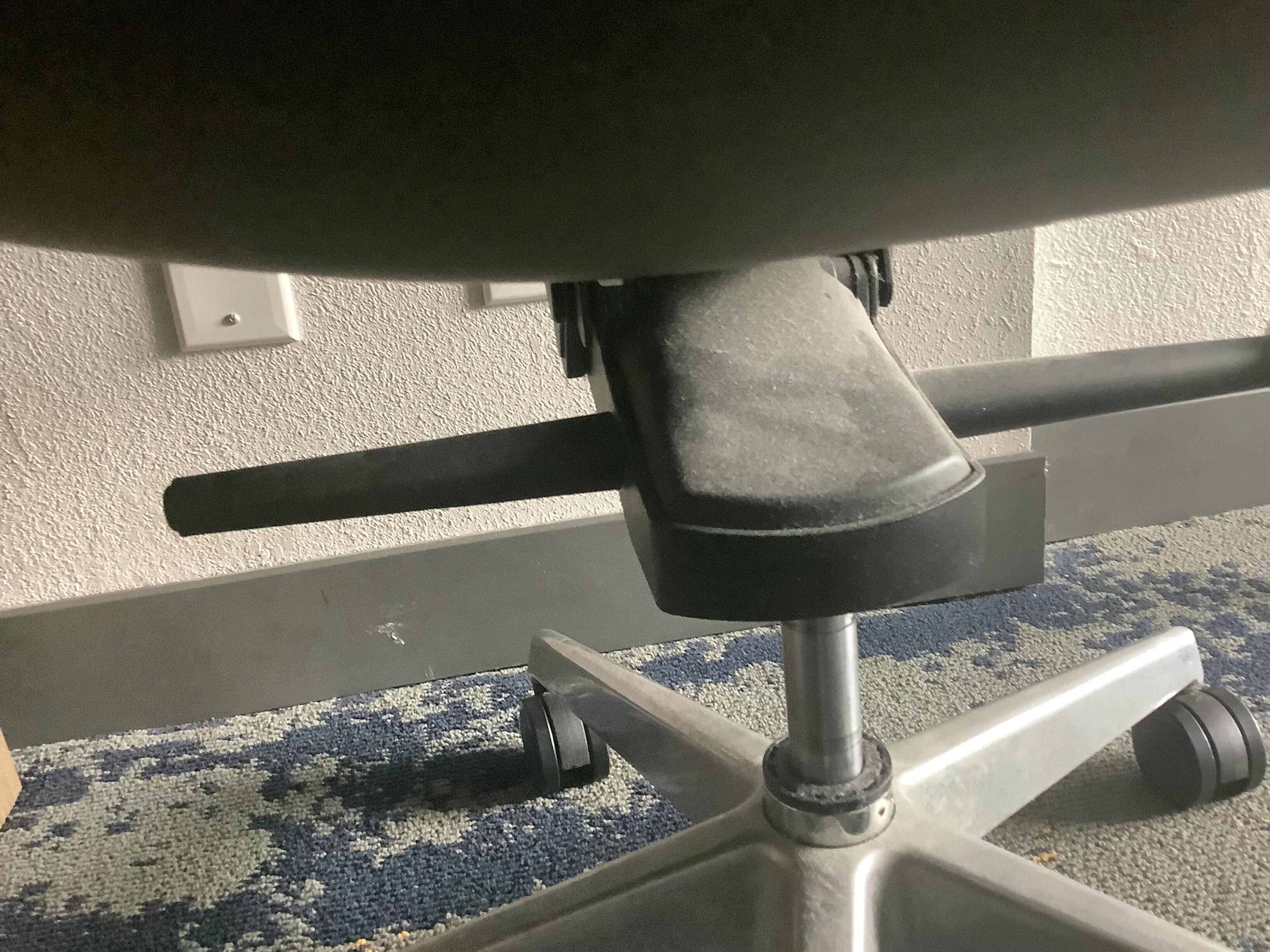 Dusty under the chair 