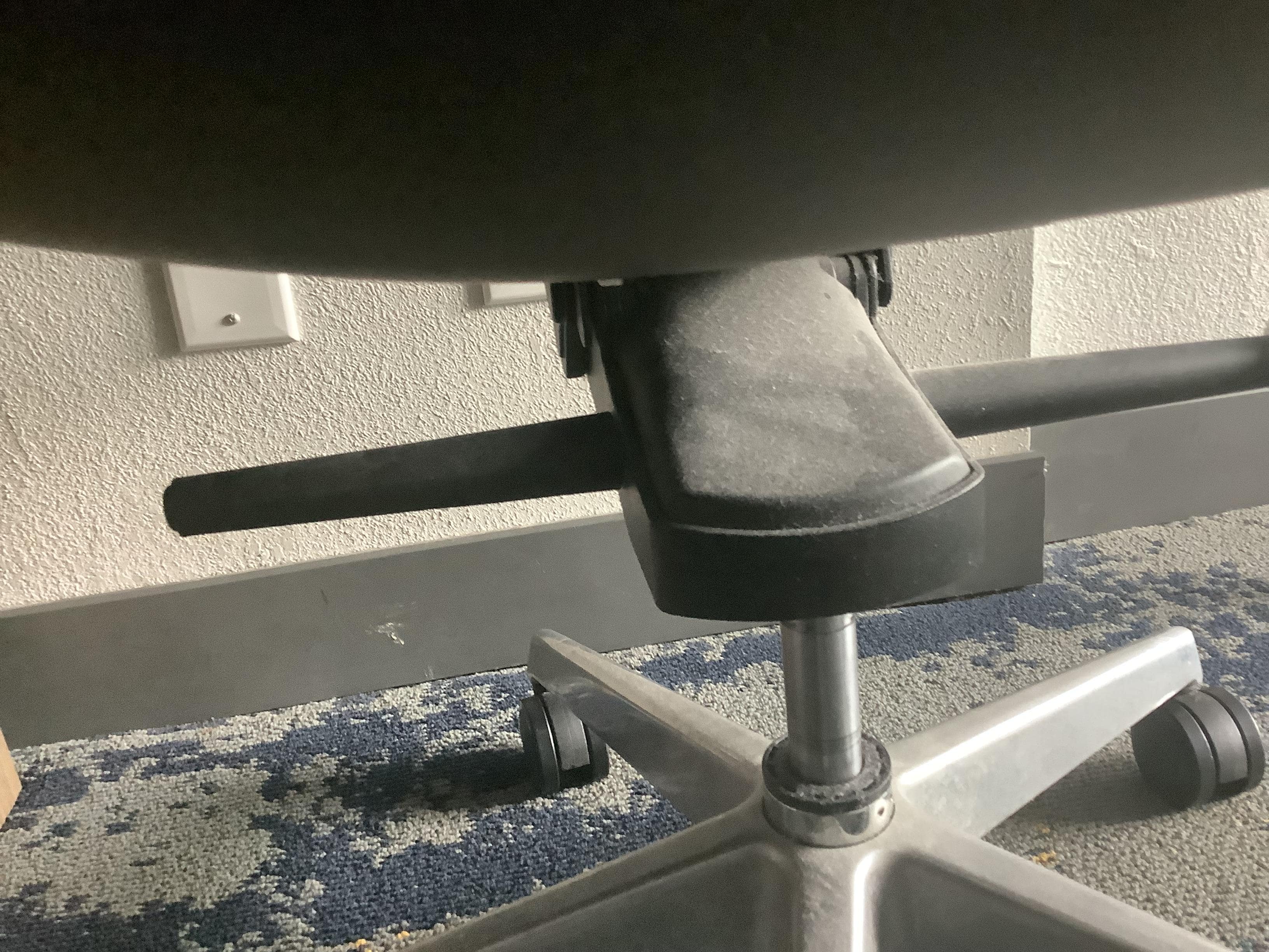 Dusty under the chair