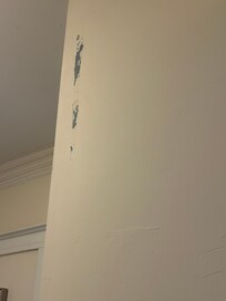 Large scrape on wall. This wall in the pic on the listing info was also altered. It has a closet with the heating unit in it and it was extremely loud when running. Not accurately shown in listing photos