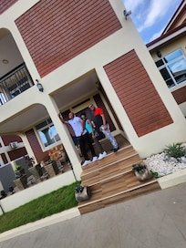 The family outside in front of house.