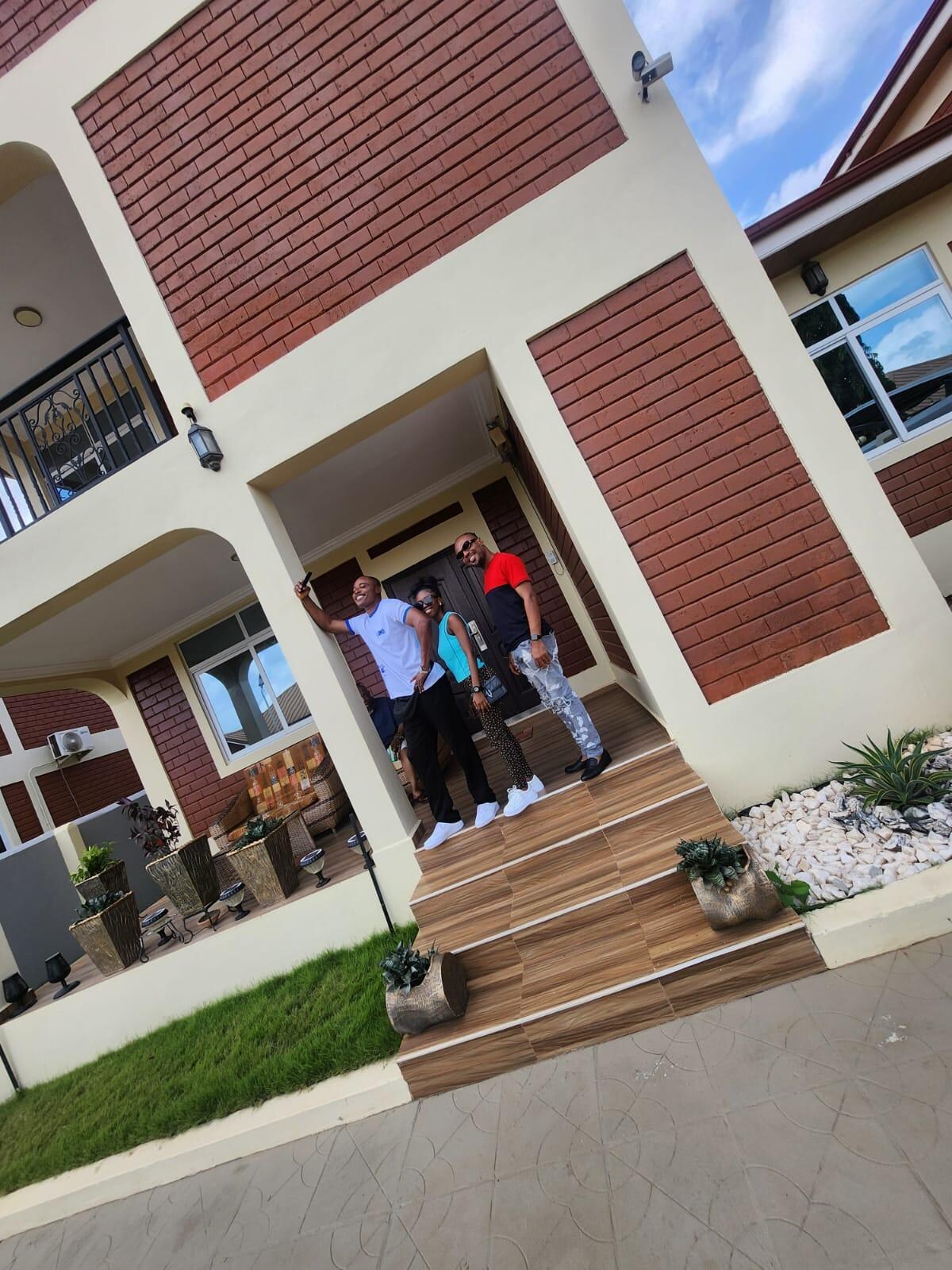 The family outside in front of house.