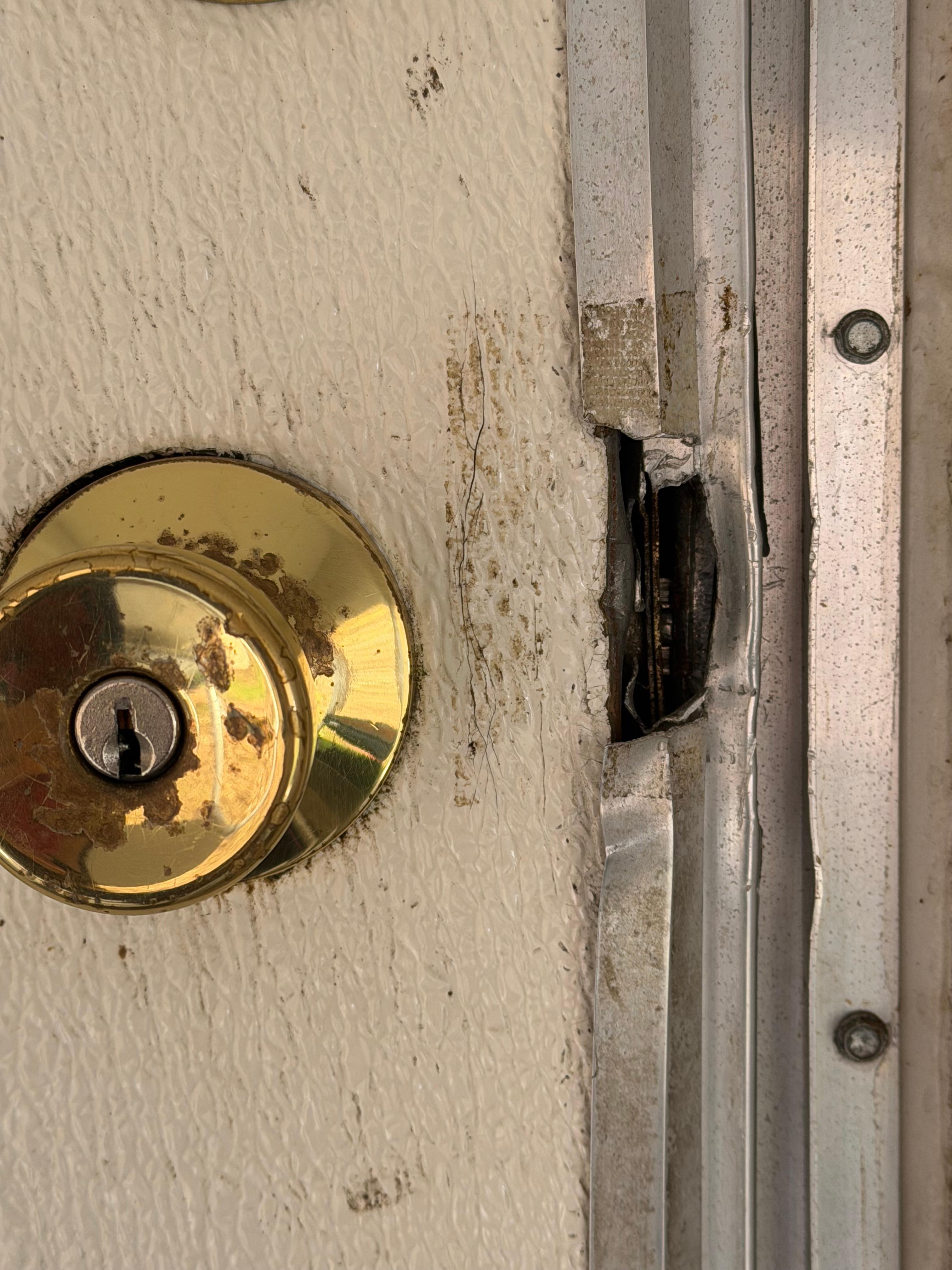 Trim cut away from door so lock not secure