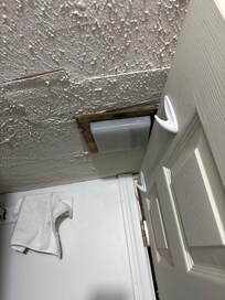 Chipping paint and bathroom door hits light.
