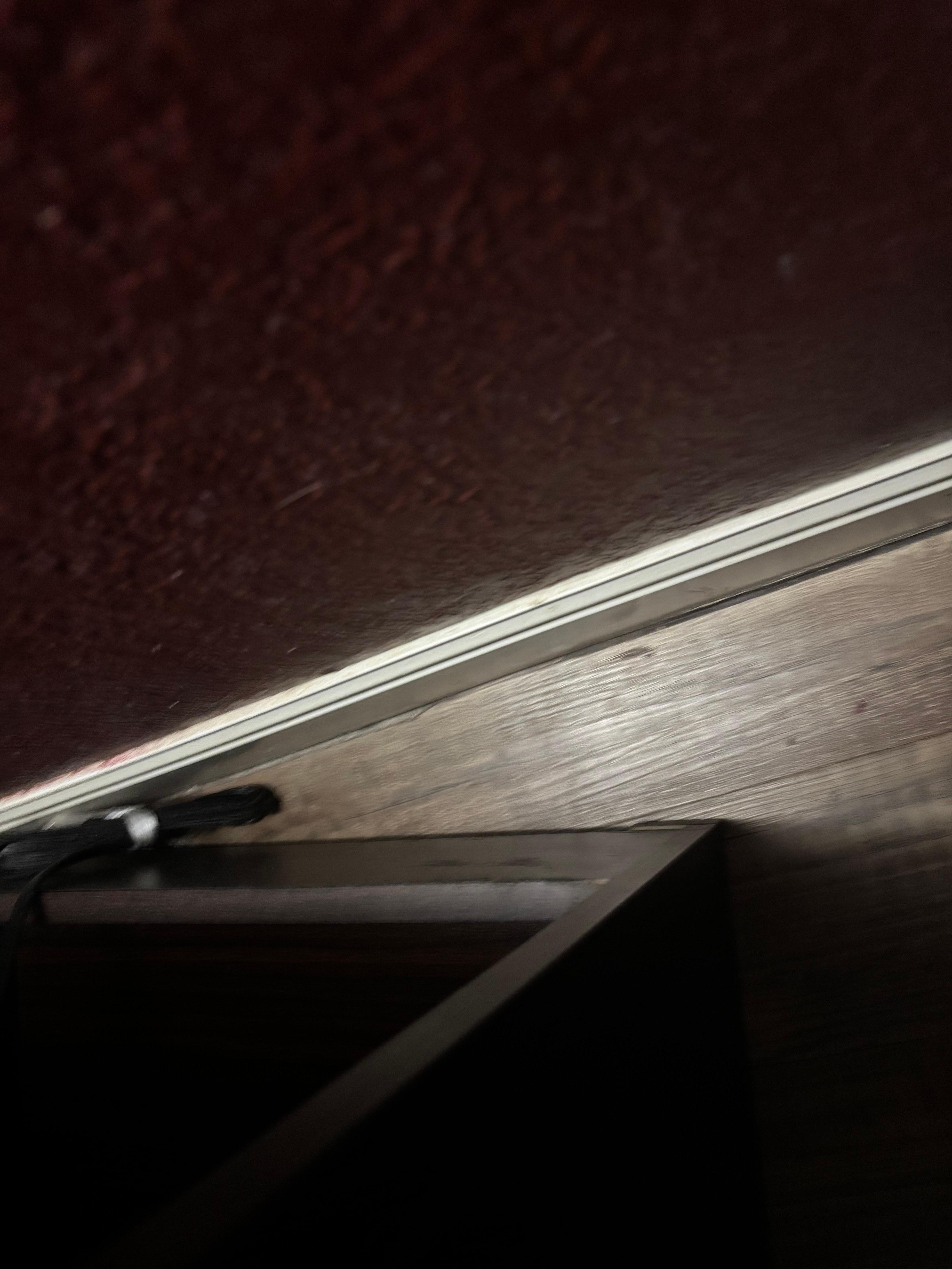 Behind the end table, folthy