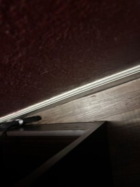 Behind the end table, folthy