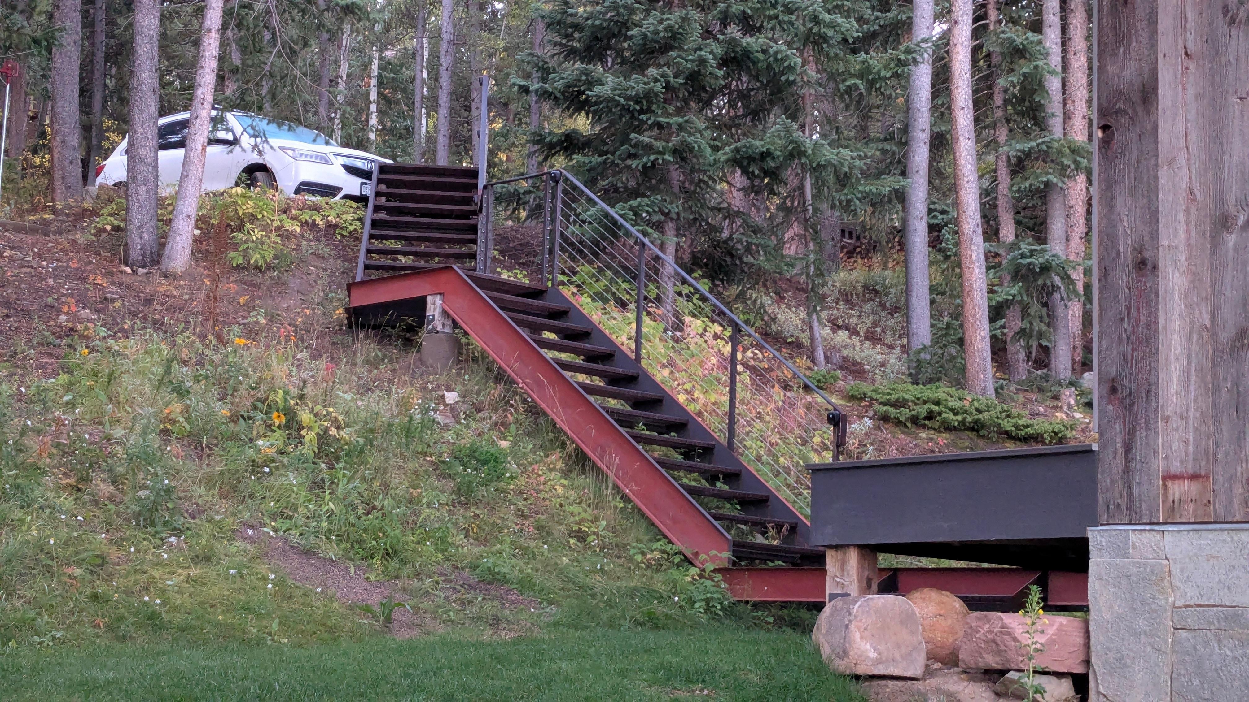 Metal grated stairs to entrance.  Be careful not to get the wheels on your luggage caught.