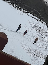 The pond froze over and the guys went out on the ice and did some ice fishing.