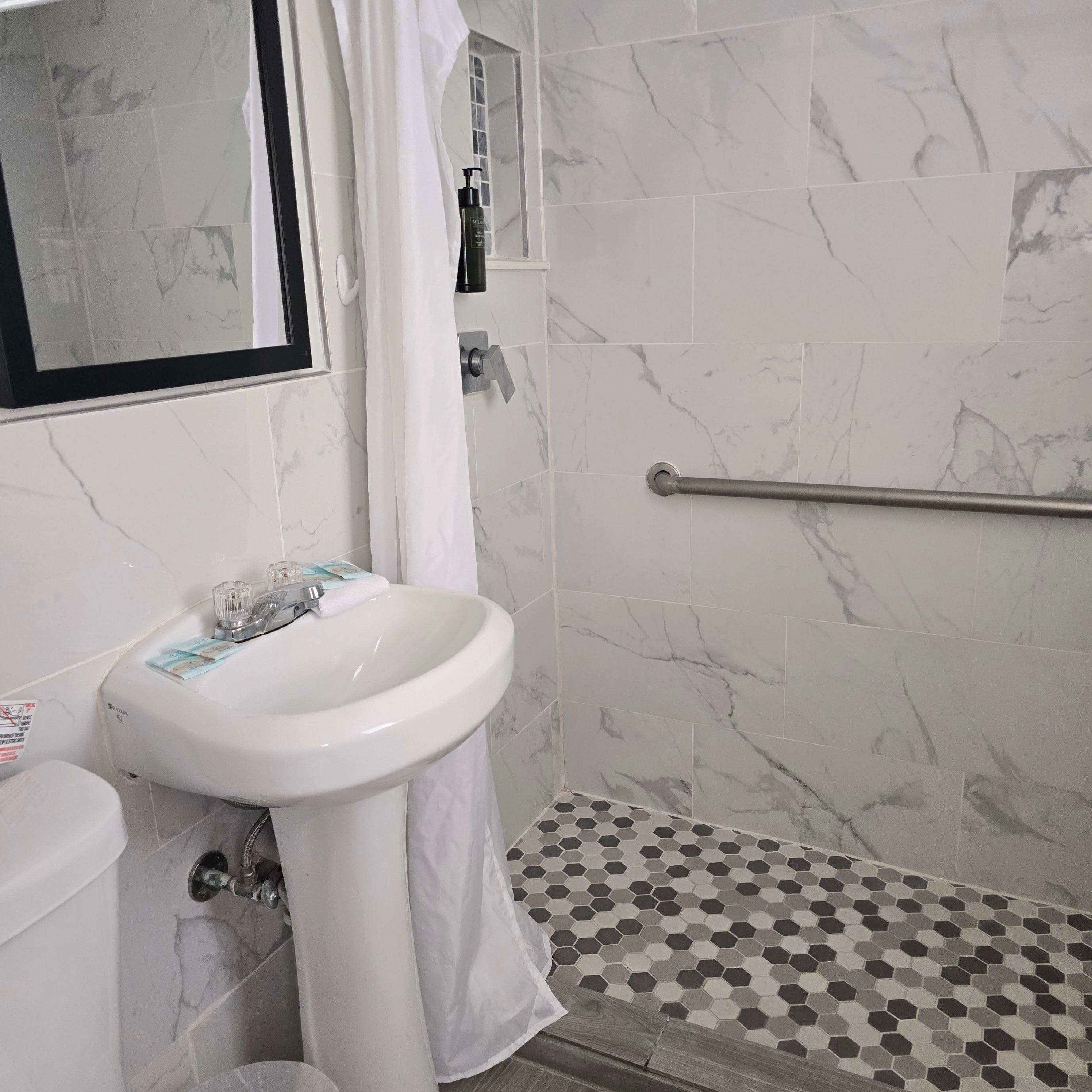Sink small but serves its purpose.  Shampoo, conditioner and soap dispenser  in shower