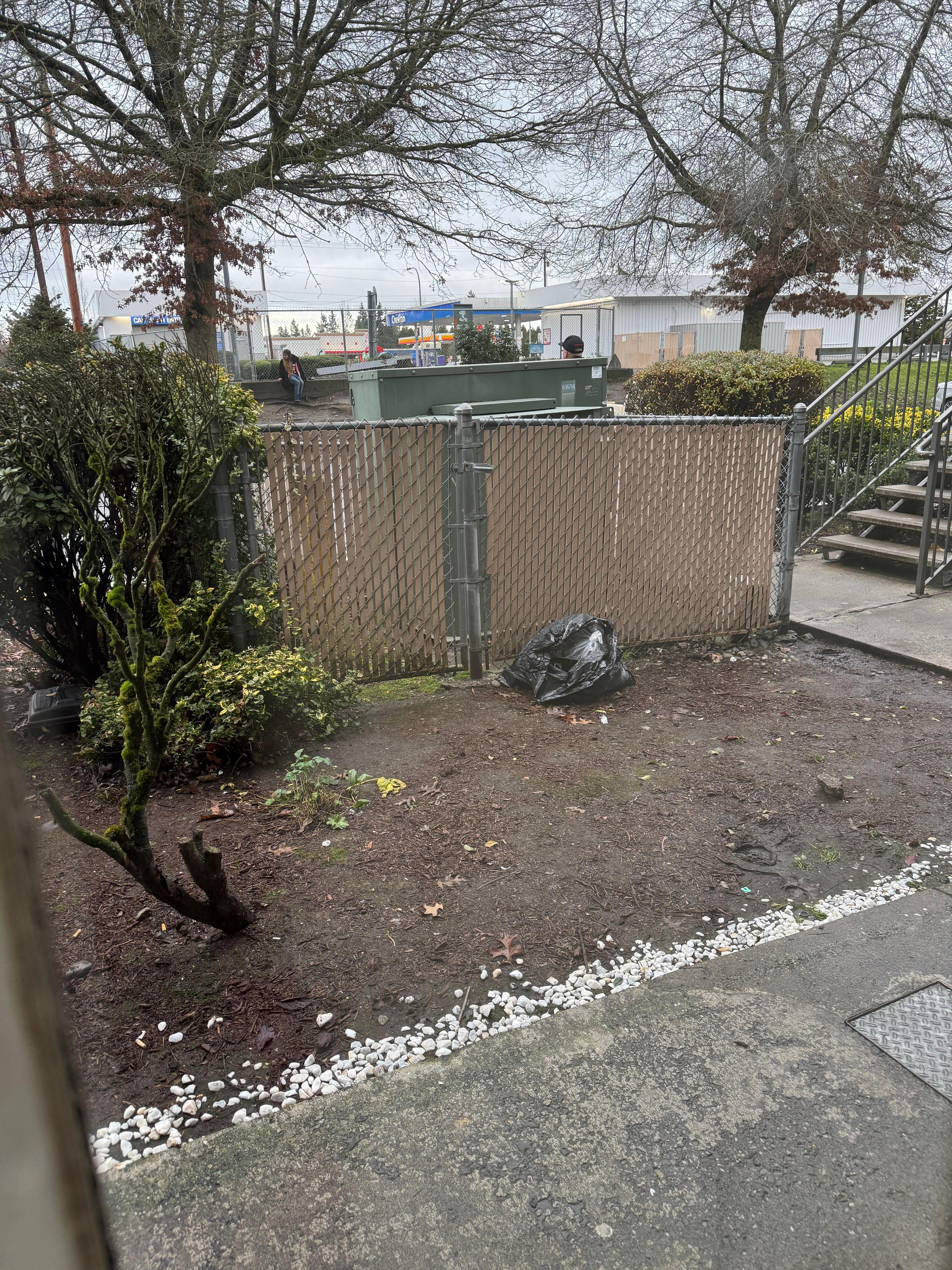 The lady in background is doing drugs, while the three men loitering outside.