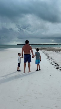 Grandpa and his boys walking the beautiful beach