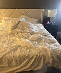 Unmade bed for three day stay