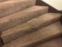 Ripped carpet in hallway