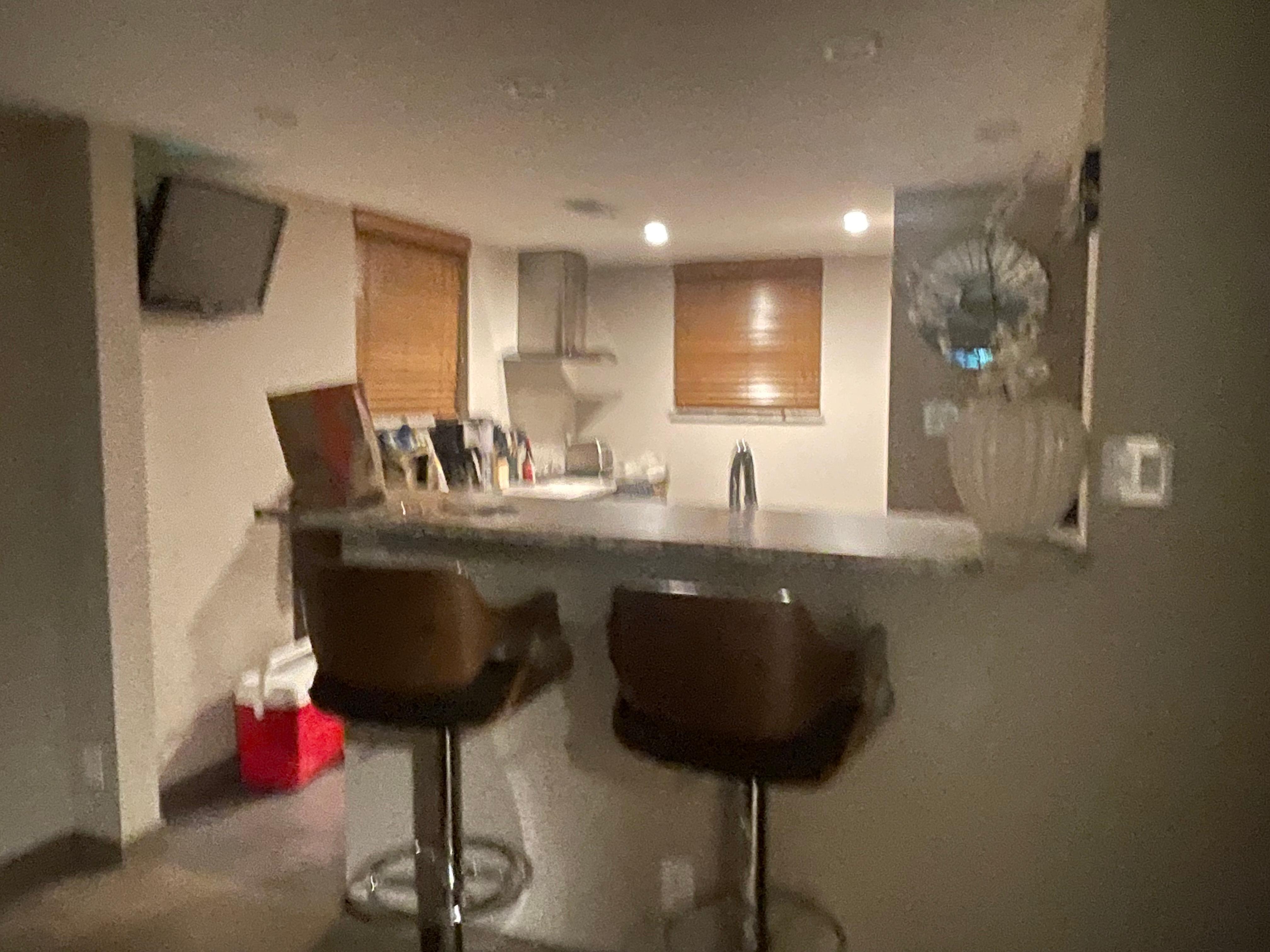 Kitchen and bar area; washer and dryer located there as well. 