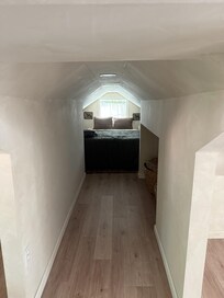 Walkway to the bedroom. The ceiling is indeed that low in the walkway and in the "bedroom" itself.