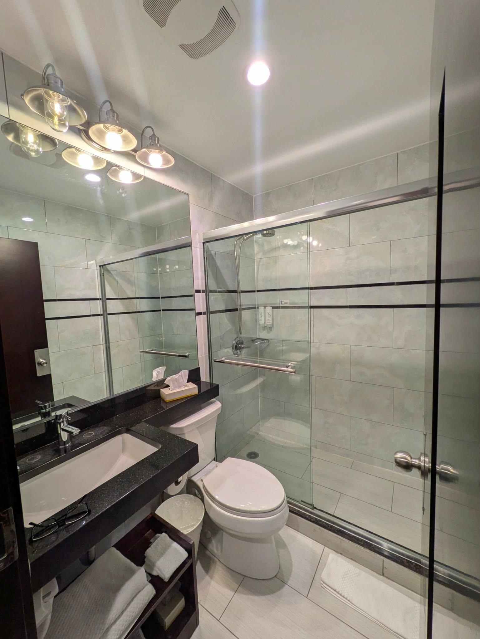 Bathroom with curbed shower. It is decent sized and the water stayed hot/warm. 