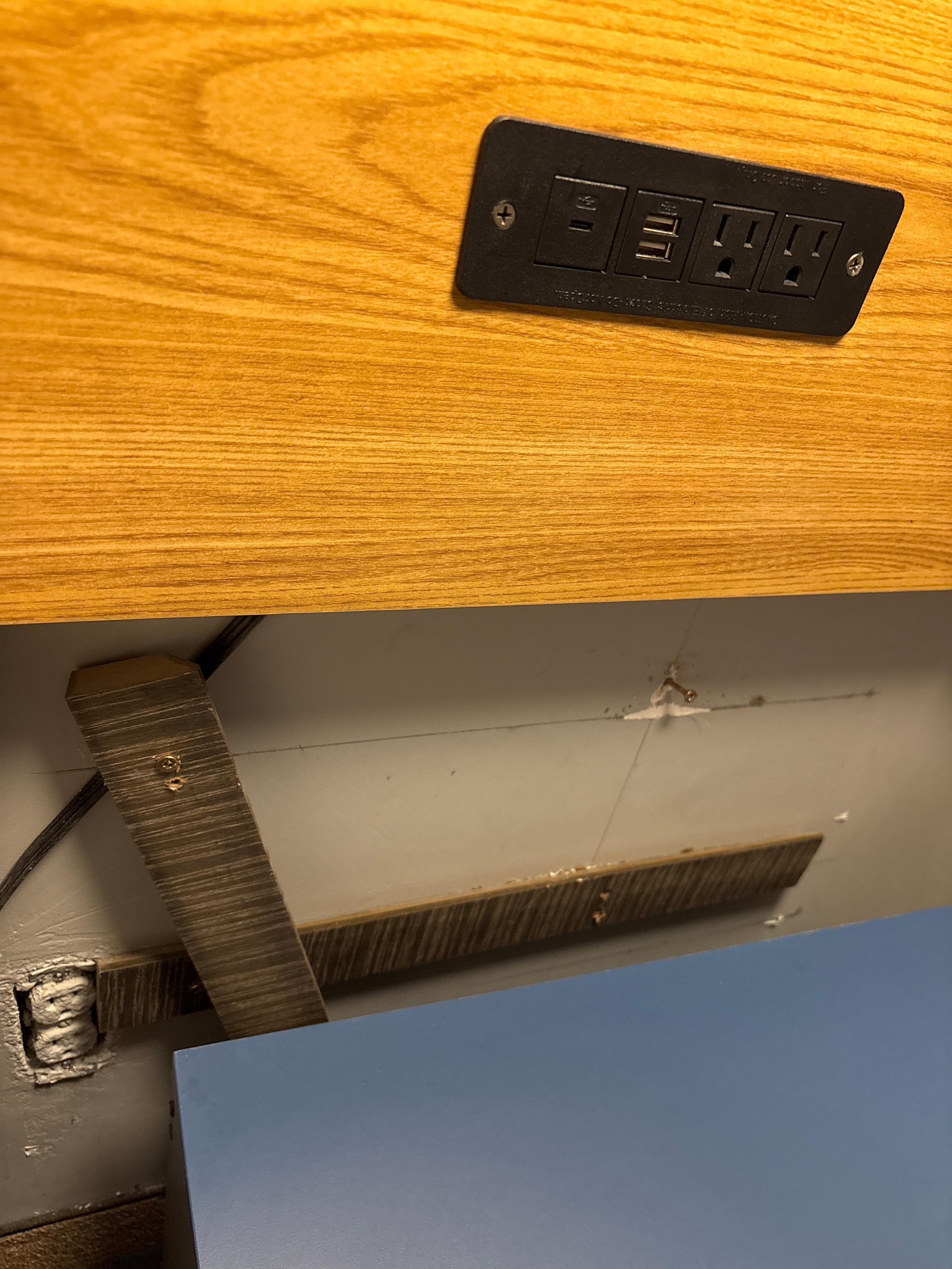 Broken furniture behind and beside the bed