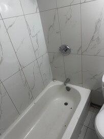 Moldy and beat up bathroom.