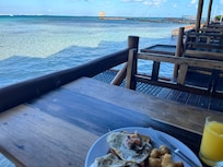 Tables at bar are directly over the water.