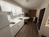 Looking at the kitchenette and the room.