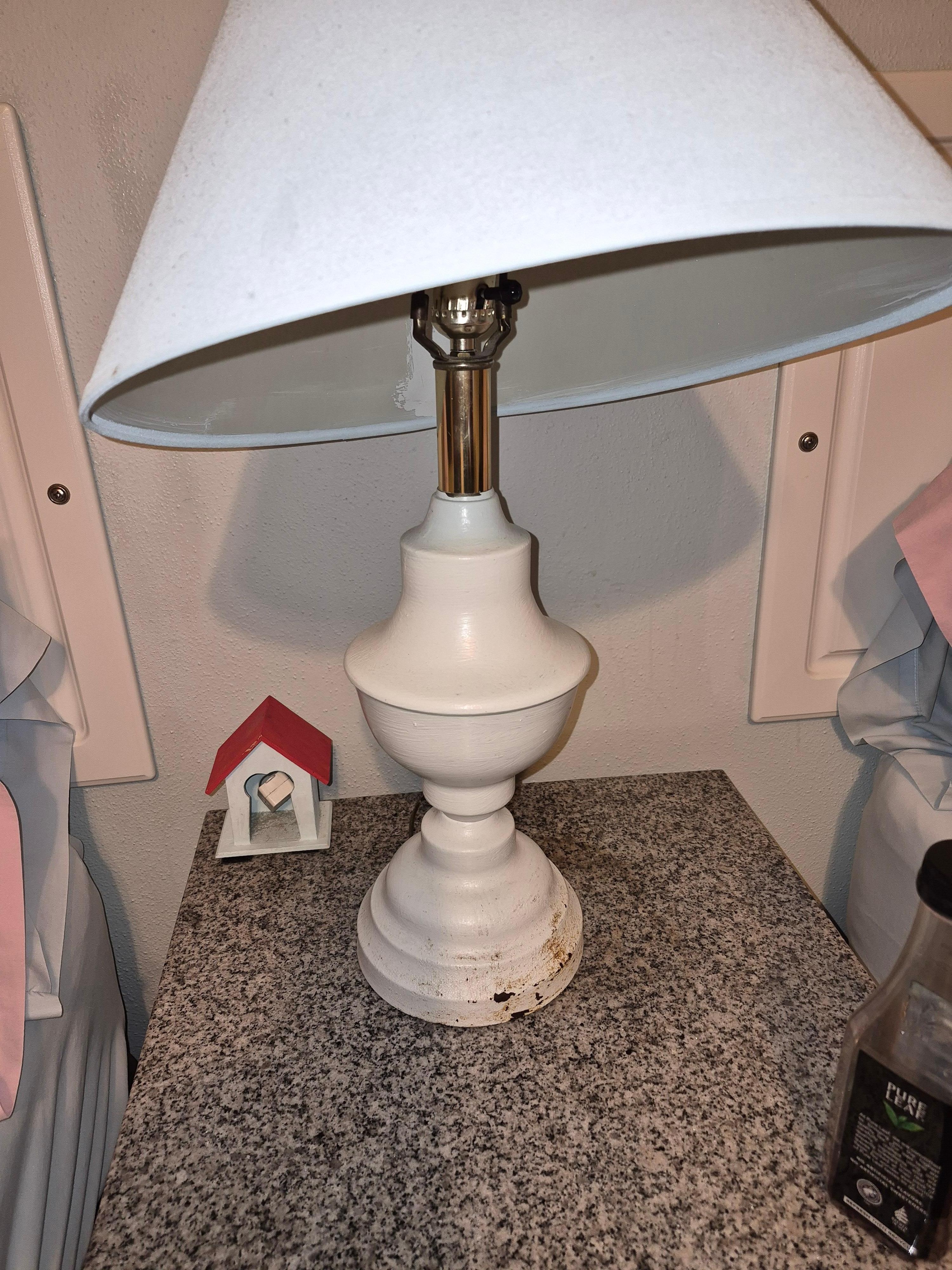 Lamp is rusted.  The little house holds your extension cord. 